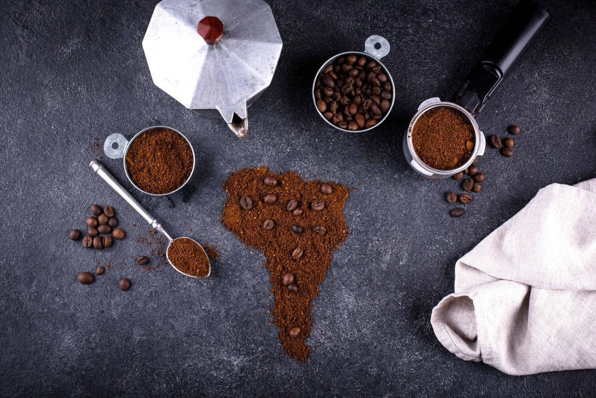 Coffee grounds at multiple grind sizes with brewing equipment on dark slate surface - His Word Coffee