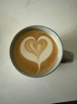 Heart-shaped latte art prepared by His Word Coffee
