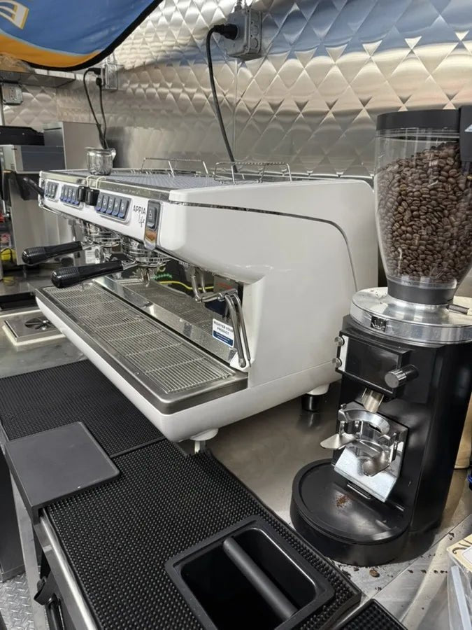 Professional Nuova Simonelli espresso machine inside the His Word Coffee trailer